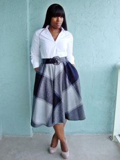 white shirt with buttons and gray, checked midi skirt with pockets