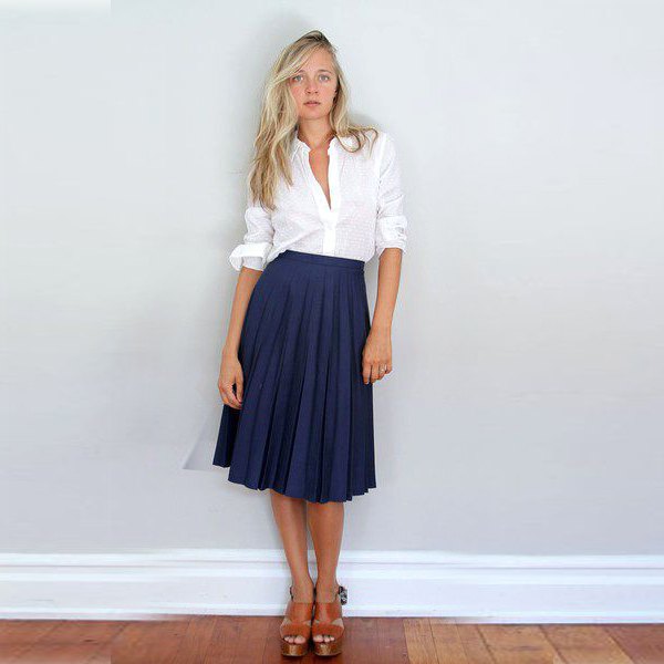 white shirt with buttons and dark blue midi pleated skirt