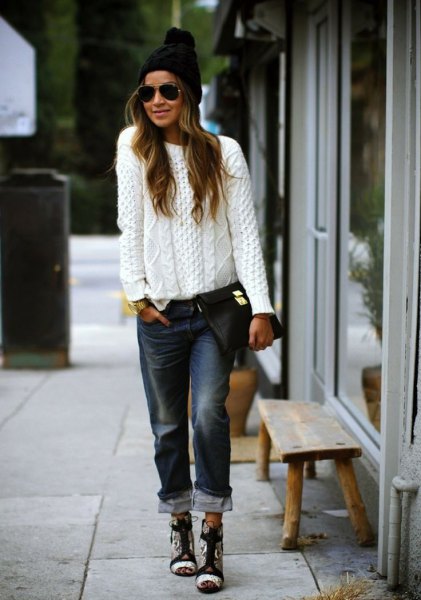 white, coarsely knitted sweater with black boyfriend jeans with cuffs and knitted hat