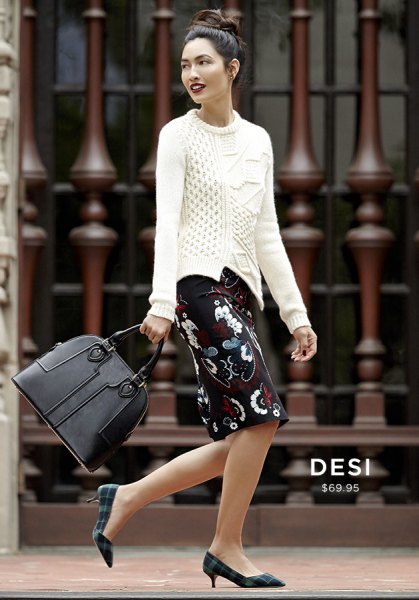 white cable knit sweater and black knee-length floral skirt