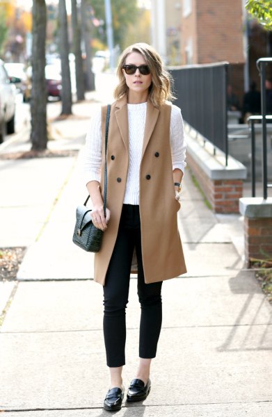 white cable knit sweater with a red, sleeveless wool coat and slippers
