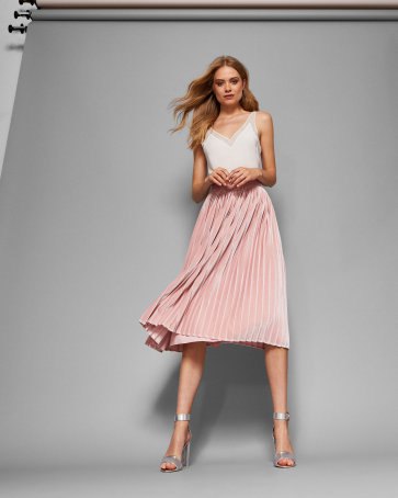 white camisole with light pink pleated skirt