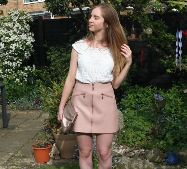 Crochet lace with white cap sleeves and pink leather mini skirt with a zipper in the front