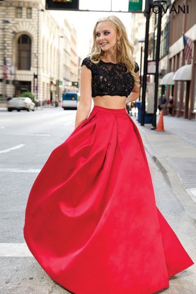 white lace blouse with cap sleeves and a red, floor-length, flared skirt