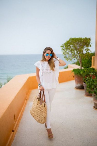 white lace top with cap sleeves and a straw bag
