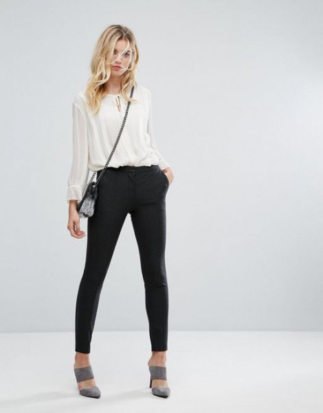 white, semi-transparent chiffon blouse with black joggers and gray heels