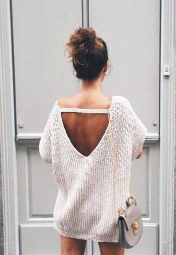 white chunky oversized sweater with an open back and mini shorts