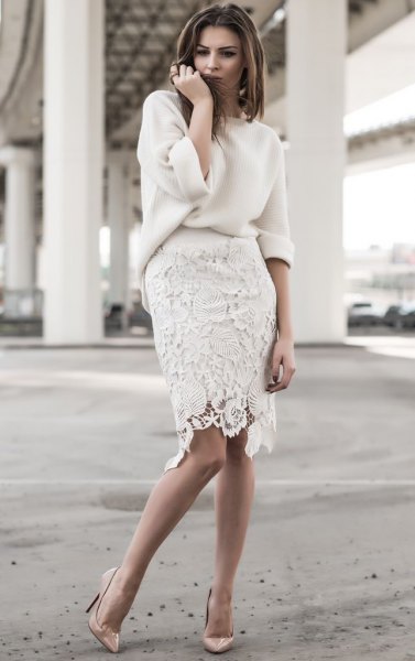 white, chunky sweater with a knee-length lace skirt
