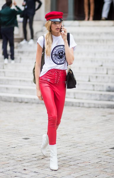 white cool graphic t-shirt with a red painter's hat and matching leather gaiters