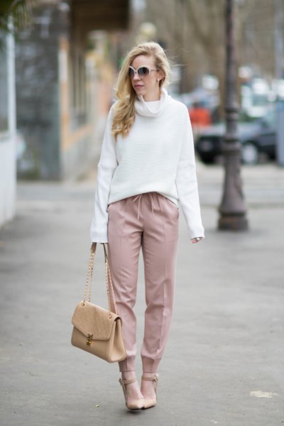 white sweater with a cowl neckline with blushing pants and heels