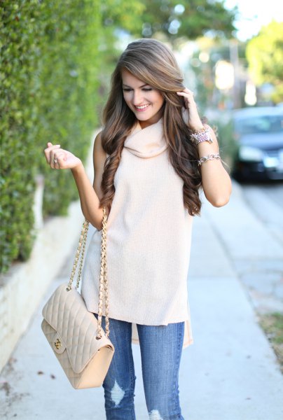 white sleeveless sweater with cowl neckline, ripped jeans