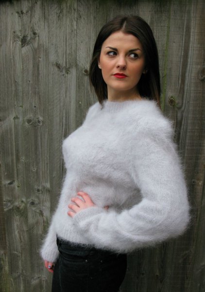 white mohair sweater with a round neckline, black skinny jeans