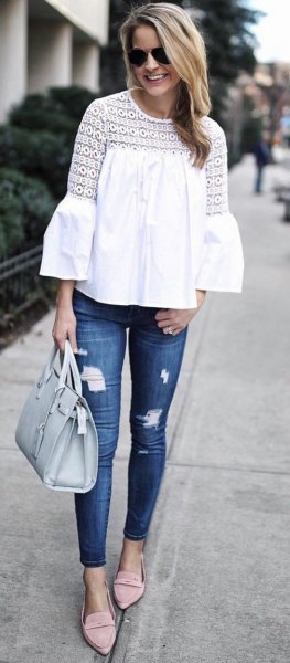 white crochet lace blouse with blue ripped skinny jeans