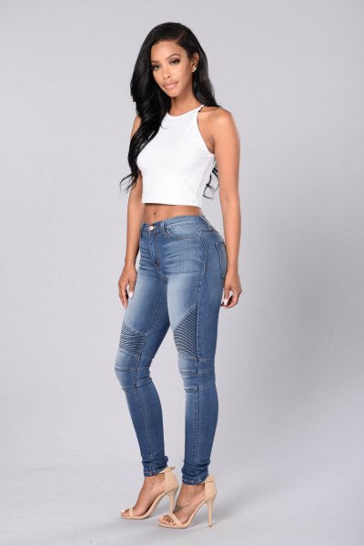 white, short halter top with blue-washed skinny moto jeans