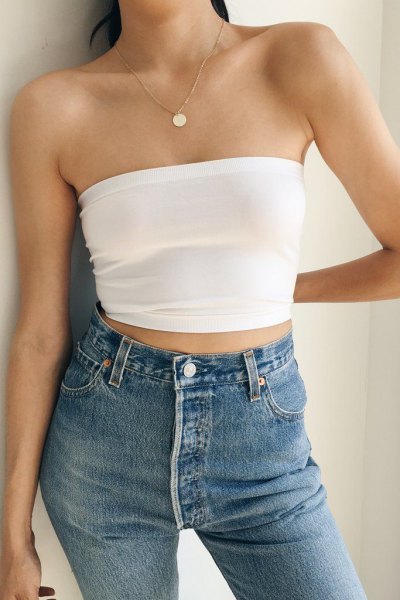 white, cropped, strapless top with blue skinny jeans