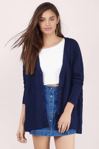 white, cropped sweater with ribbed dark blue cardigan and denim skirt
