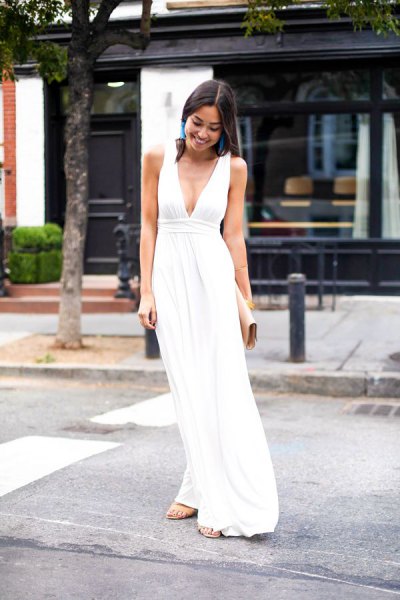 white, deep V-neck maxi dress with a gathered waist and silver heels