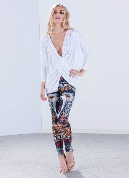 white, deep-sleeved, long-sleeved top with a V-neckline and leggings with tribal print