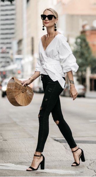 white wrap shirt with deep V-neck and black skinny jeans