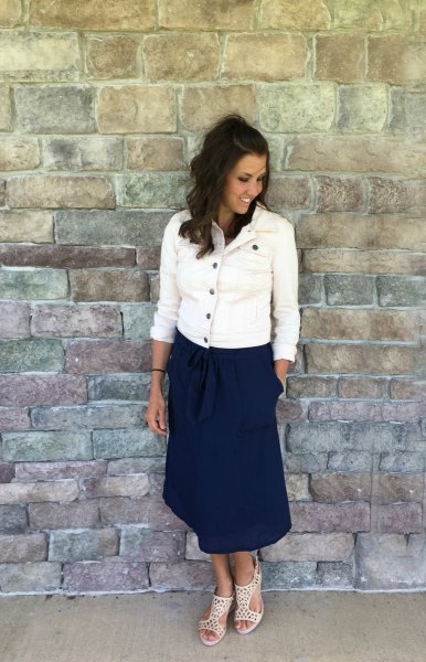 white denim jacket with buttons and dark blue midi skirt with a relaxed fit