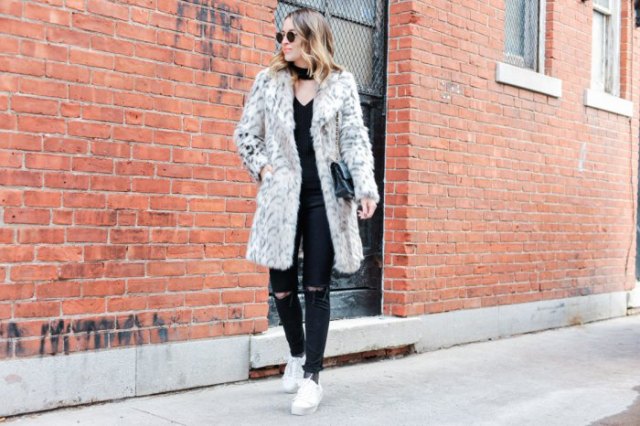 long coat made of white faux fur with ripped jeans and sneakers