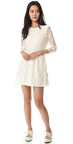 white mini dress with pointed and flared tip and wing tip shoes
