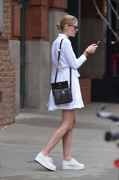 white cut and flared long-sleeved shirt dress with black handbag over the shoulder