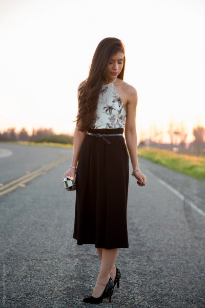 white halterneck top with floral pattern and black midi high-rise skirt