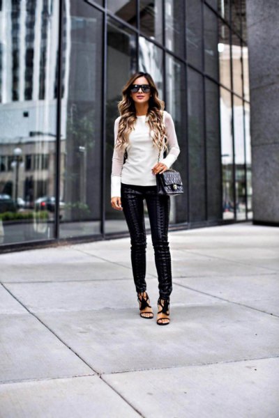 white, figure-hugging long-sleeved sweater with leather gaiters and open toe heels