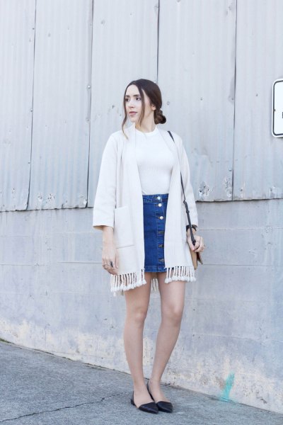 white cardigan with fringes and blue mini skirt