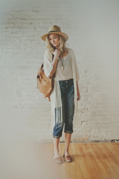 white fringed longline cardigan with white straw hat and blushing pink slide sandals