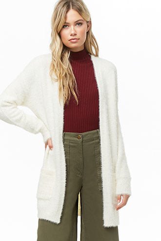 white fuzzy long cardigan with green ribbed wide-leg sweater and wide-leg pants