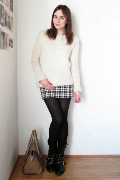 white fuzzy sweater with a mini plaid skirt made of wool and stockings