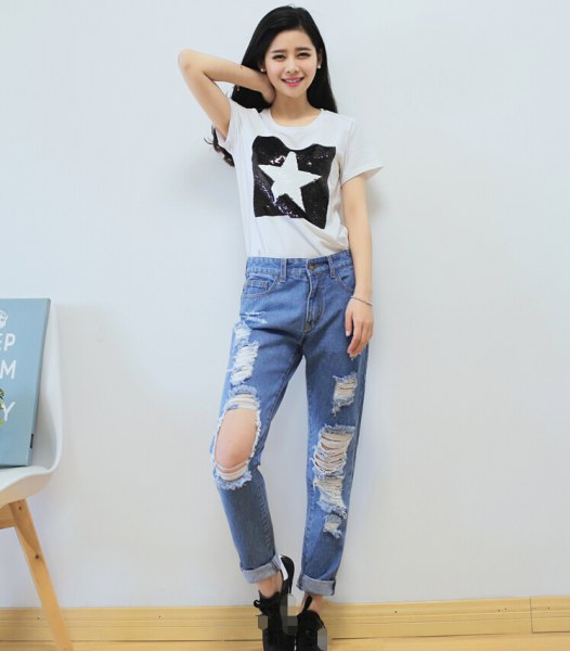 white graphic t-shirt with light blue ripped boyfriend jeans
