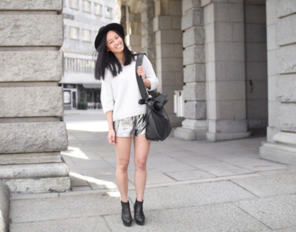 white knitted sweater with half sleeves, silver shorts and felt hat