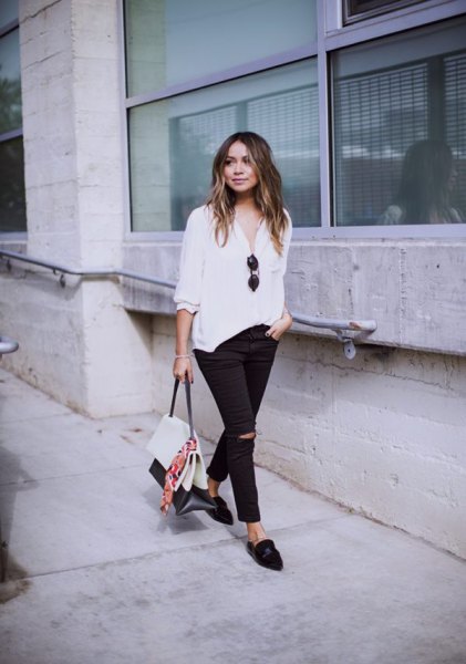 white blouse with relaxed fit and black slip fit jeans and slippers