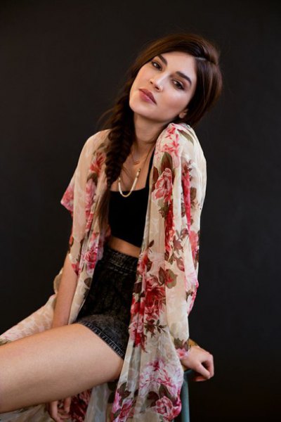 white kimono with black, cropped denim shorts with a vest