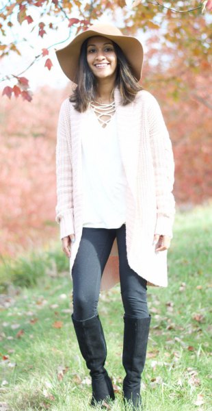 white cardigan with gray leggings and knee-high boots