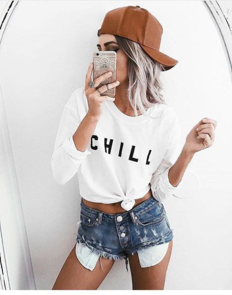 white knotted long-sleeved T-shirt with high-waisted distressed shorts