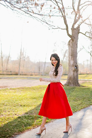 white lace blouse with a flared skirt made of red midi taffeta