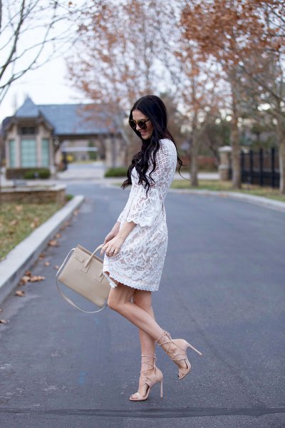 Mini swing dress with white lace and scalloped hem and pink strappy heels