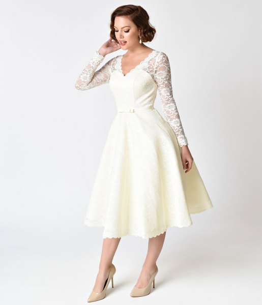 white lace dress with scalloped edge and swing dress in the style of the 1950s