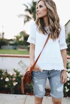 white lace top with ripped long shorts made of gray denim