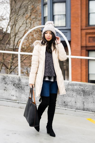 white long down coat with a heather gray sweater and overknee boots