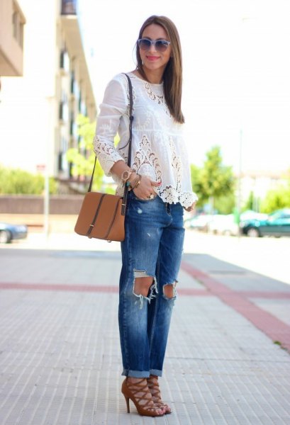white long-sleeved blouse with ripped jeans and red strappy lace-up shoes