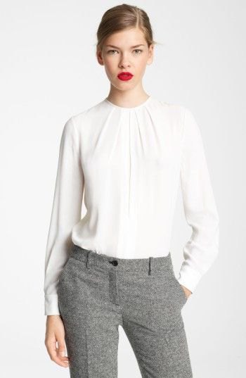 white long-sleeved blouse with round neckline and relaxed fit and tweed trousers