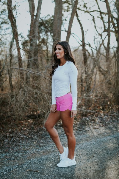 white, long-sleeved, fitted t-shirt with gray, high-waisted mini running shorts