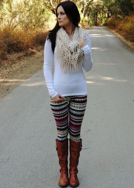 white, long-sleeved, figure-hugging t-shirt with leggings with tribal print and brown boots
