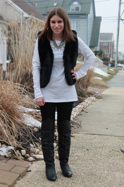 white long-sleeved tunic top with black jeans and knee-high leather boots