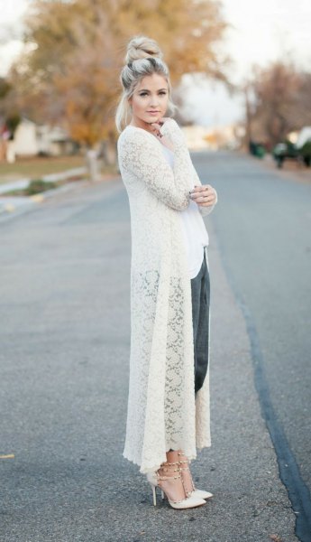 white maxi crochet sweater cardigan with black, cropped trousers